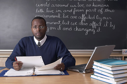 Male teacher sitting at desk