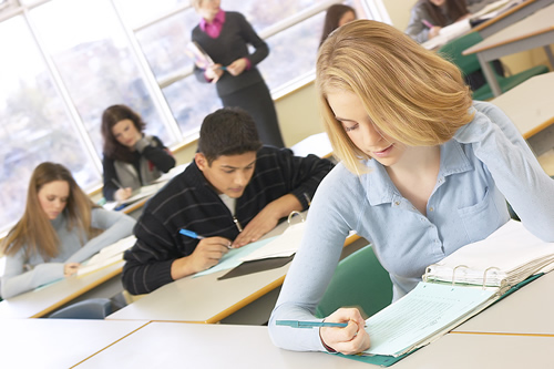 students writing in notebook during test 