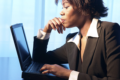 woman typing on laptop computer