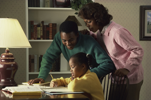 Parents helping daughter with homework 