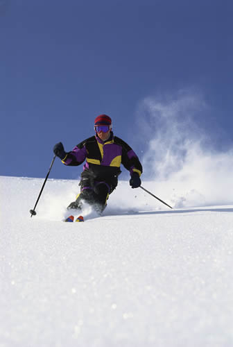 Male skiing down a hill slope